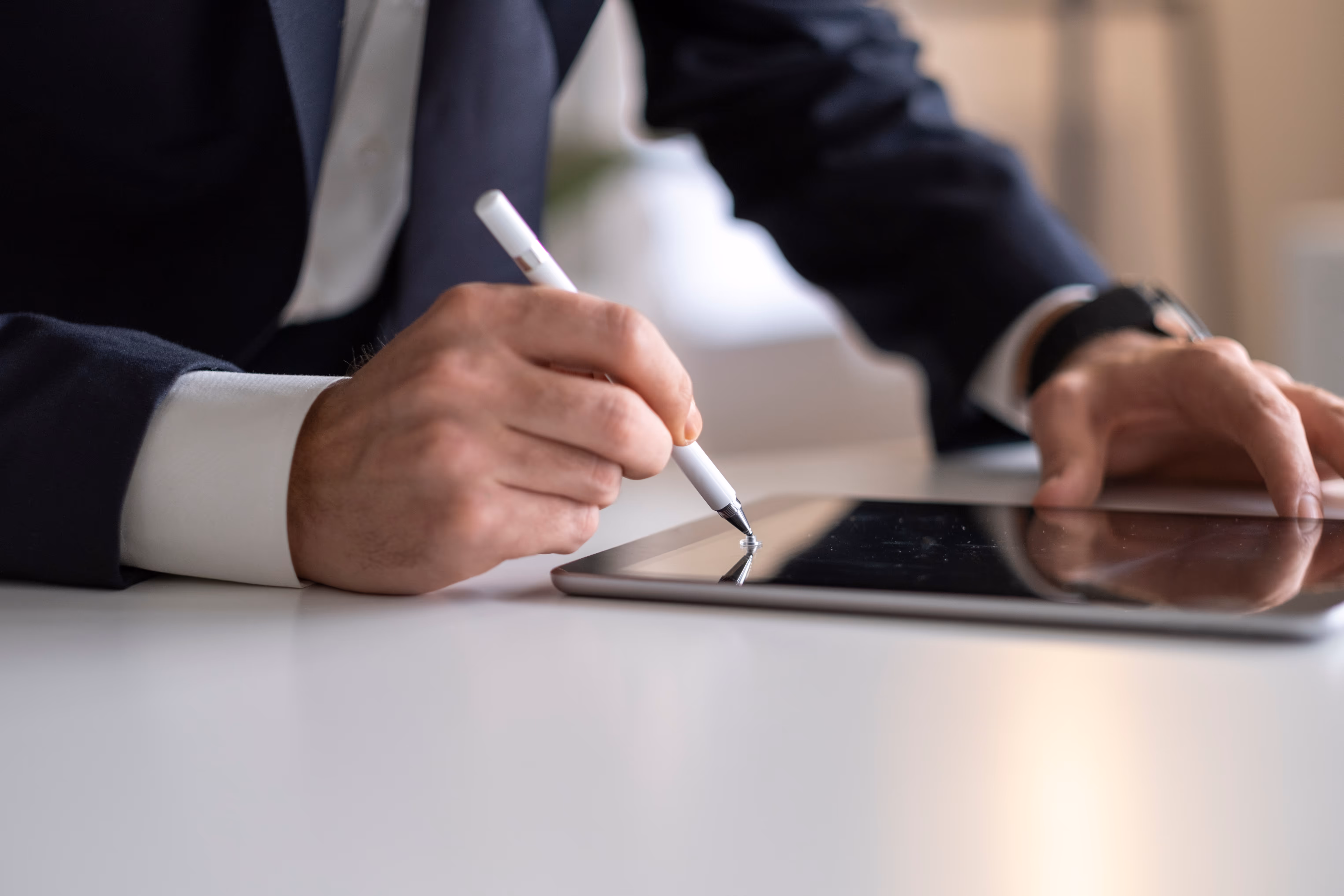 Business Man Using mobile apps on iPad with digital pencil